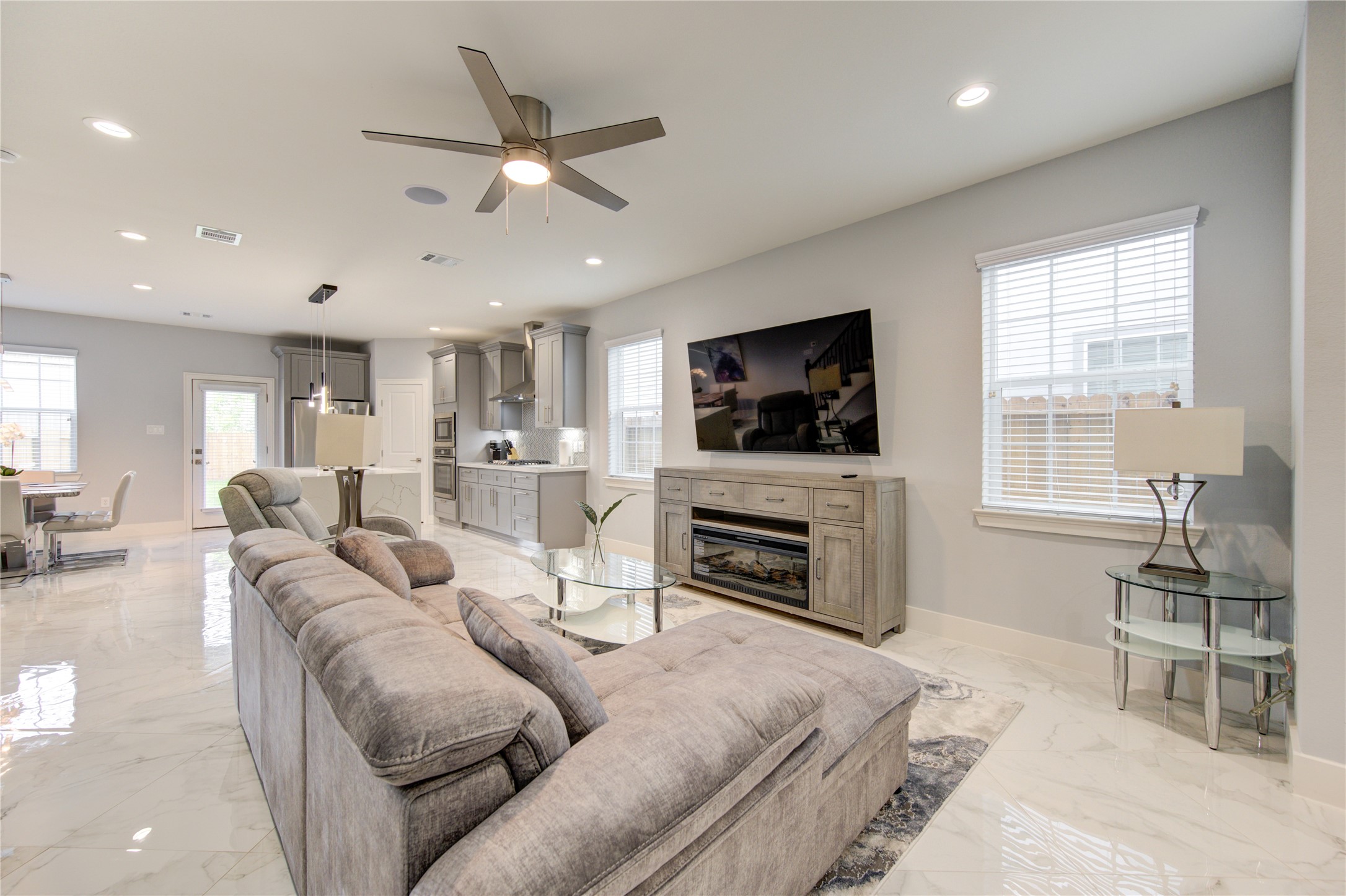 10021 Alfred Lane, Unit B Houston, TX 77041 - Photo 16 of 46 a living room with furniture a fireplace and a flat screen tv