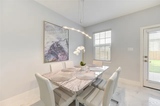 a view of a dining room with furniture and window