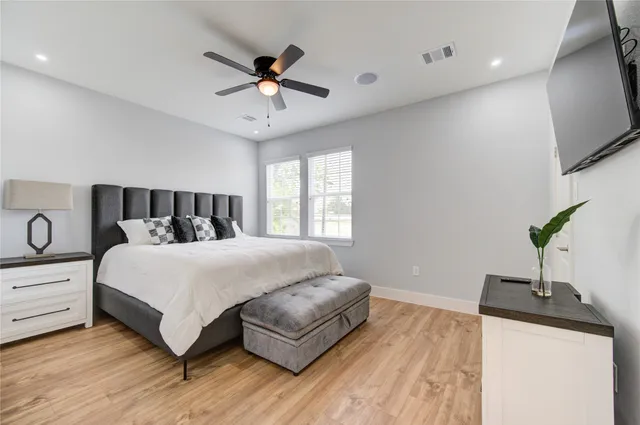 a bedroom with a bed and a potted plant