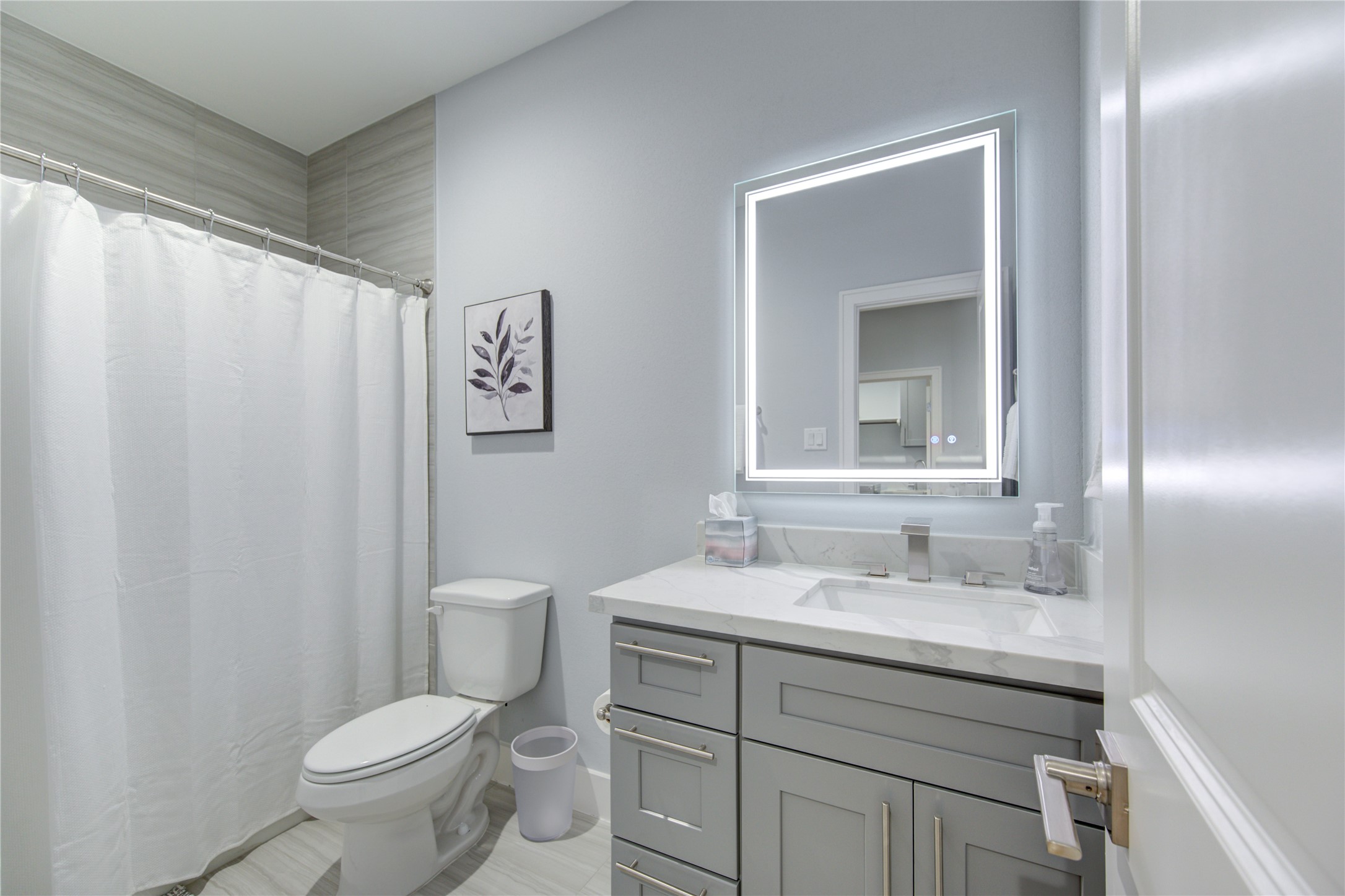 10021 Alfred Lane, Unit B Houston, TX 77041 - Photo 30 of 46 a bathroom with a toilet sink vanity and mirror