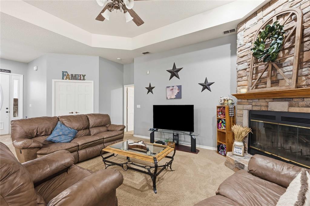 34106 Trilby Road Dade City, FL 33523 - Photo 21 of 39 a living room with furniture and a fireplace