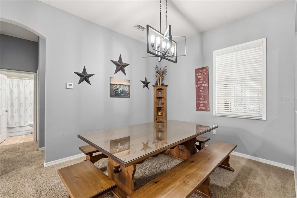 34106 Trilby Road Dade City, FL 33523 - Photo 23 of 39 a living room with a table chairs and a window