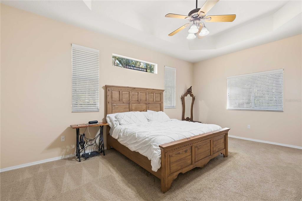 34106 Trilby Road Dade City, FL 33523 - Photo 27 of 39 a bed sitting in a bedroom next to a window