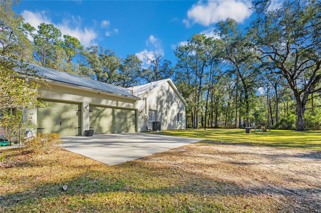 34106 Trilby Road Dade City, FL 33523 - Photo 36 of 39 a view of a house with a big yard and large trees