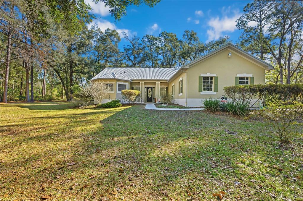 34106 Trilby Road Dade City, FL 33523 - Photo 37 of 39 a view of house with outdoor space and garden