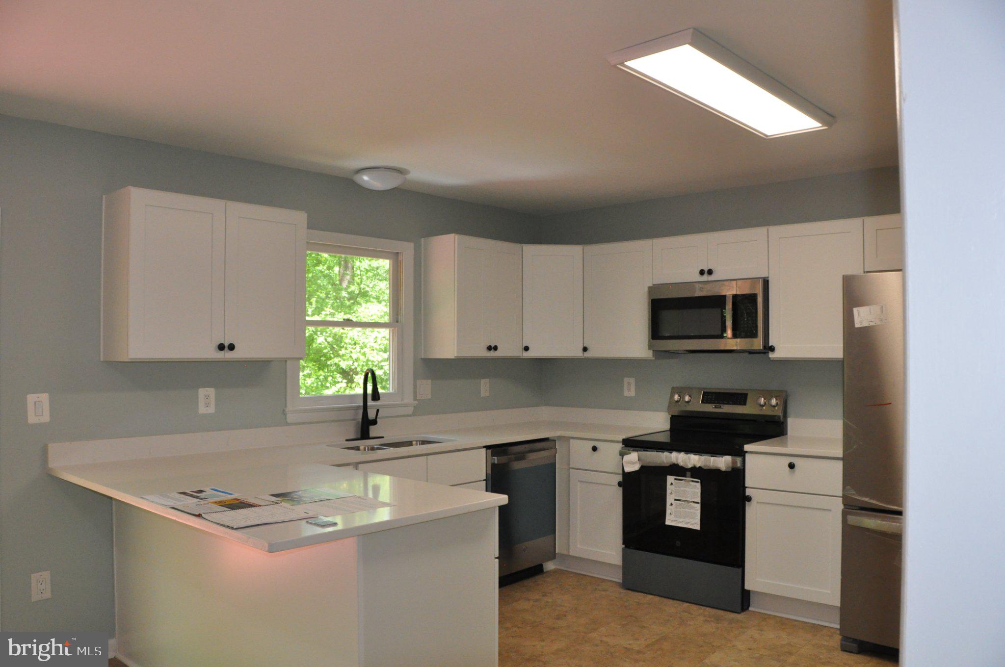 28 Henry Way Linden, VA 22642 - Photo 7 of 39 a kitchen with stainless steel appliances granite countertop a sink stove and refrigerator