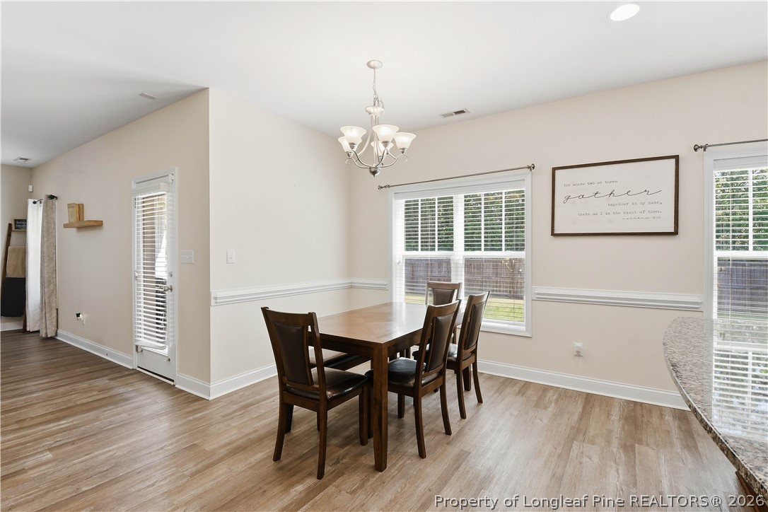 140 Birch Avenue Spring Lake, NC 28390 - Photo 21 of 49 a view of a dining room with furniture and wooden floor