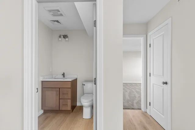 a bathroom with a toilet sink and a mirror
