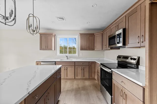 a kitchen with a sink stove and microwave