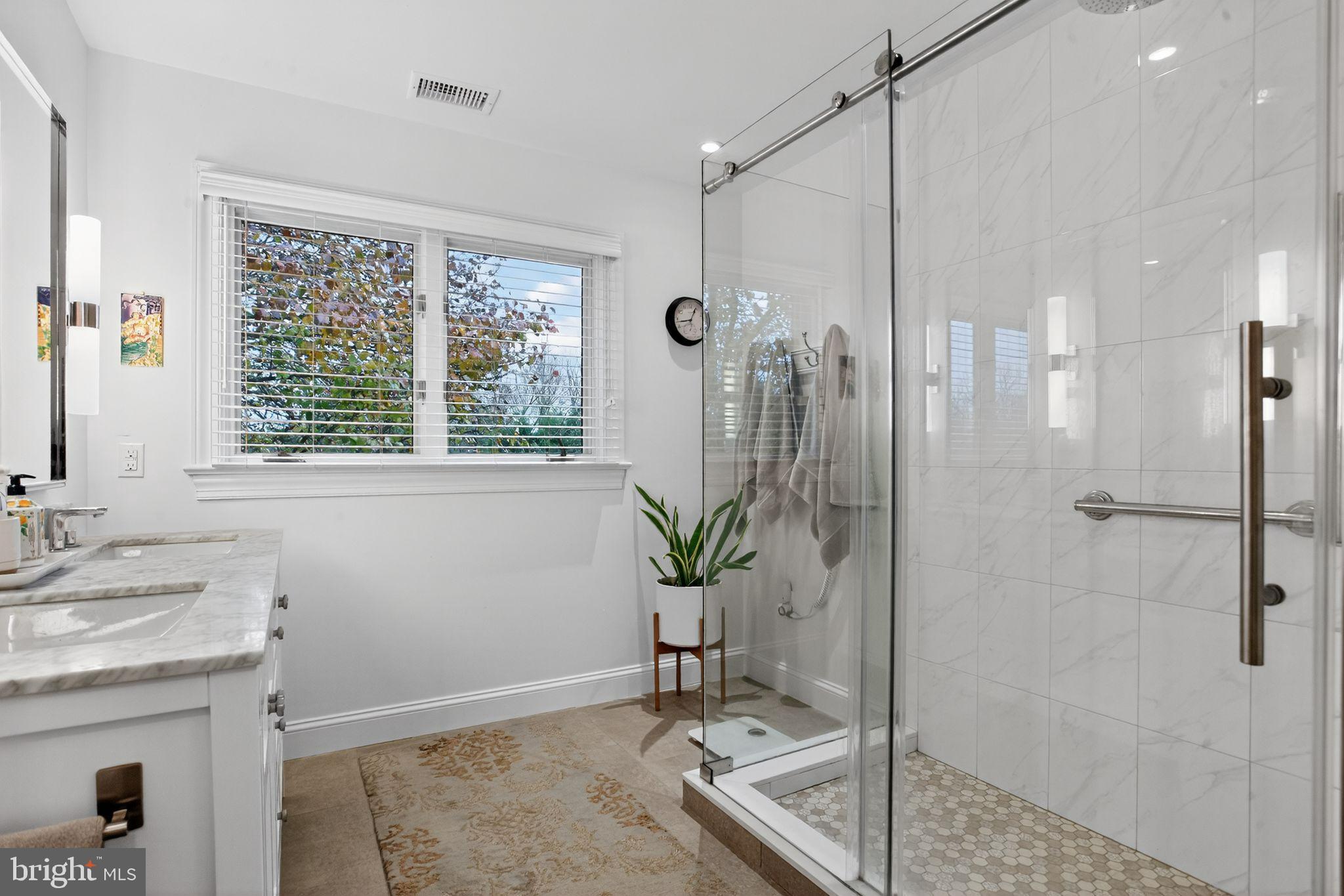 149 Splitrail Lane Blue Bell, PA 19422 - Photo 27 of 40 a bathroom with a granite countertop sink a mirror a window and a shower