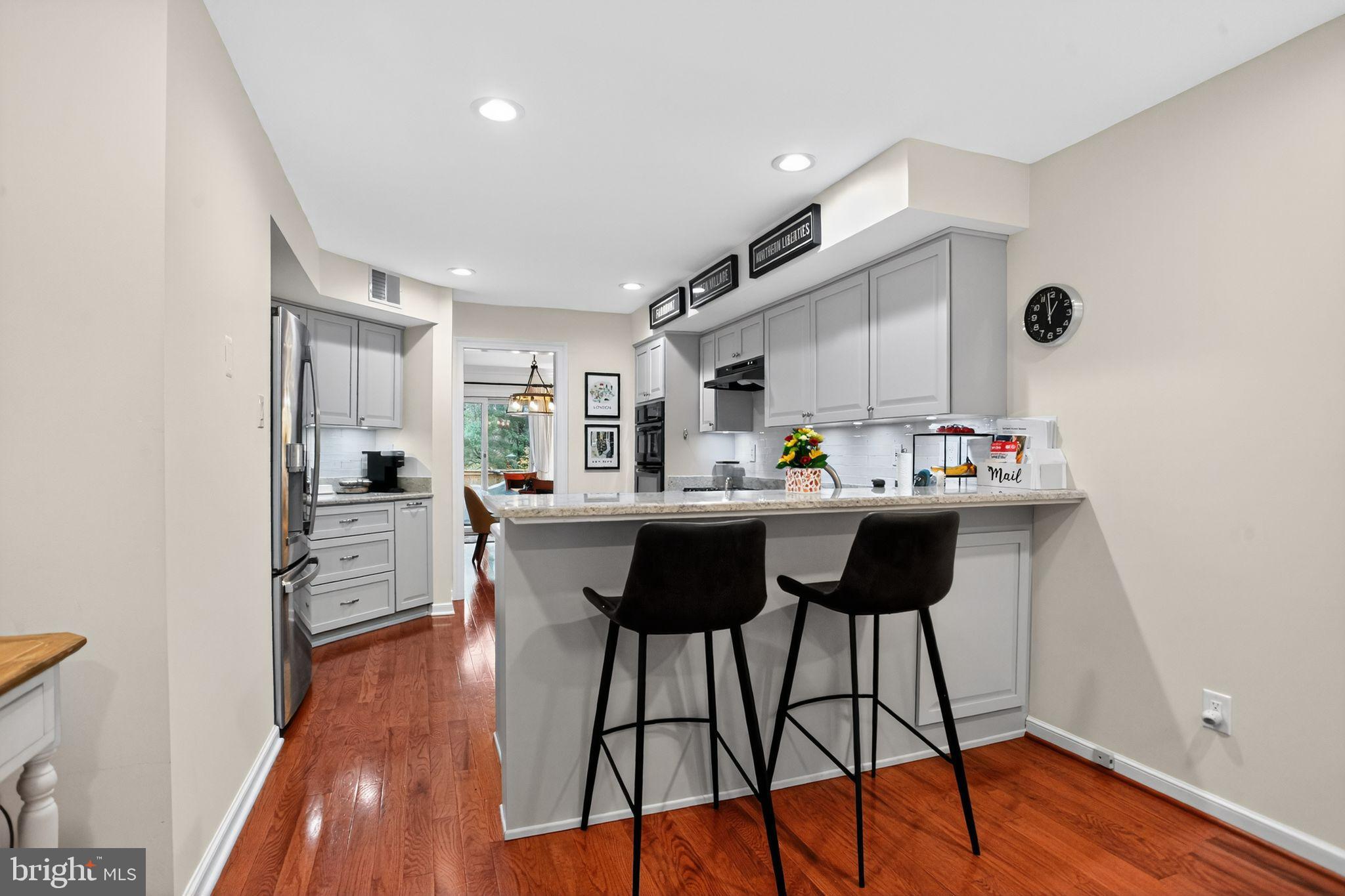 149 Splitrail Lane Blue Bell, PA 19422 - Photo 9 of 40 a kitchen with stainless steel appliances a dining table chairs stove and sink