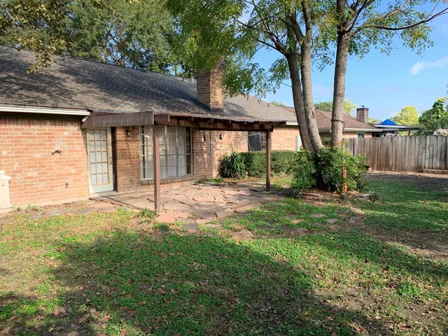 a view of a swimming pool with a lawn chairs under an umbrella