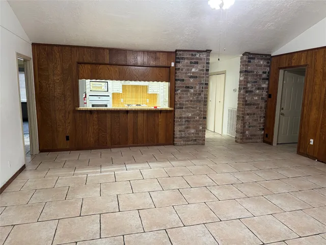 an empty room with fireplace and fan