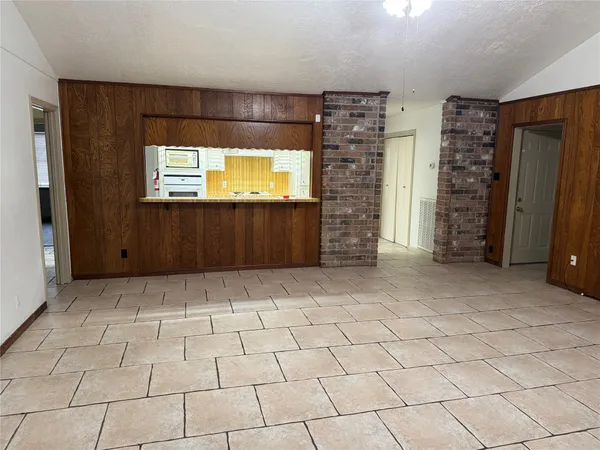 an empty room with fireplace and fan