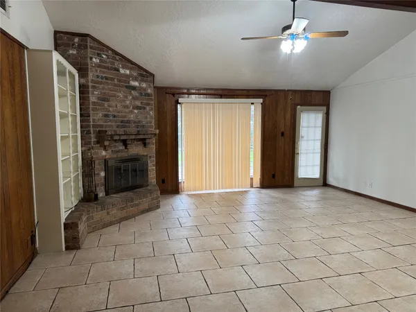 an empty room with closet and a chandelier fan