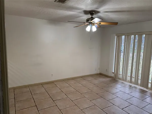 an empty room with wooden floor a ceiling fan and closet