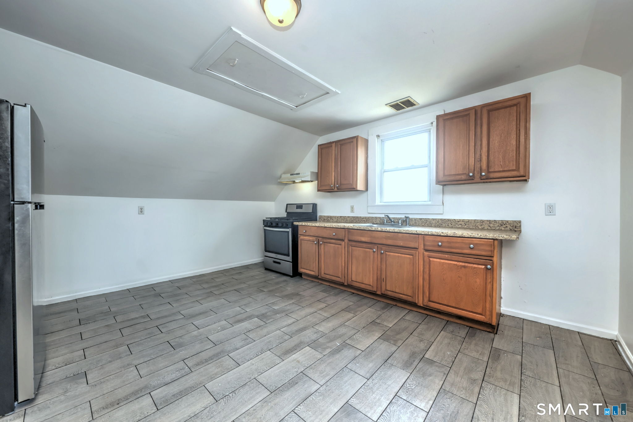 483 Ferry Street, Unit 3 New Haven, CT 06513 - Photo 19 of 28 a kitchen with a stove a sink and a refrigerator