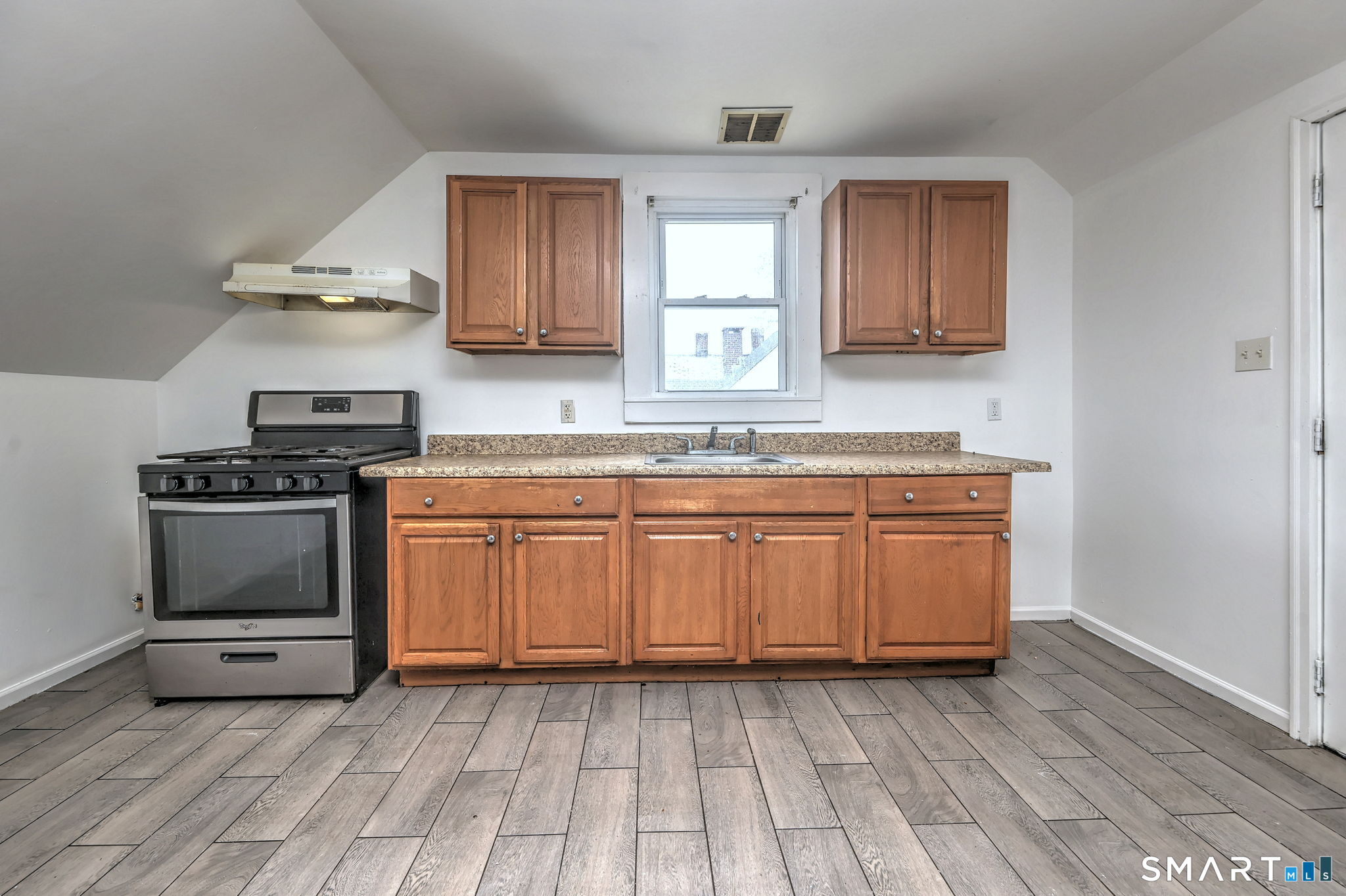 483 Ferry Street, Unit 3 New Haven, CT 06513 - Photo 20 of 28 a kitchen with granite countertop a sink cabinets and stainless steel appliances