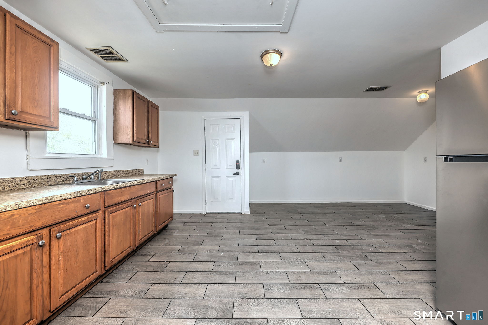 483 Ferry Street, Unit 3 New Haven, CT 06513 - Photo 22 of 28 a view of a kitchen with a sink and cabinets