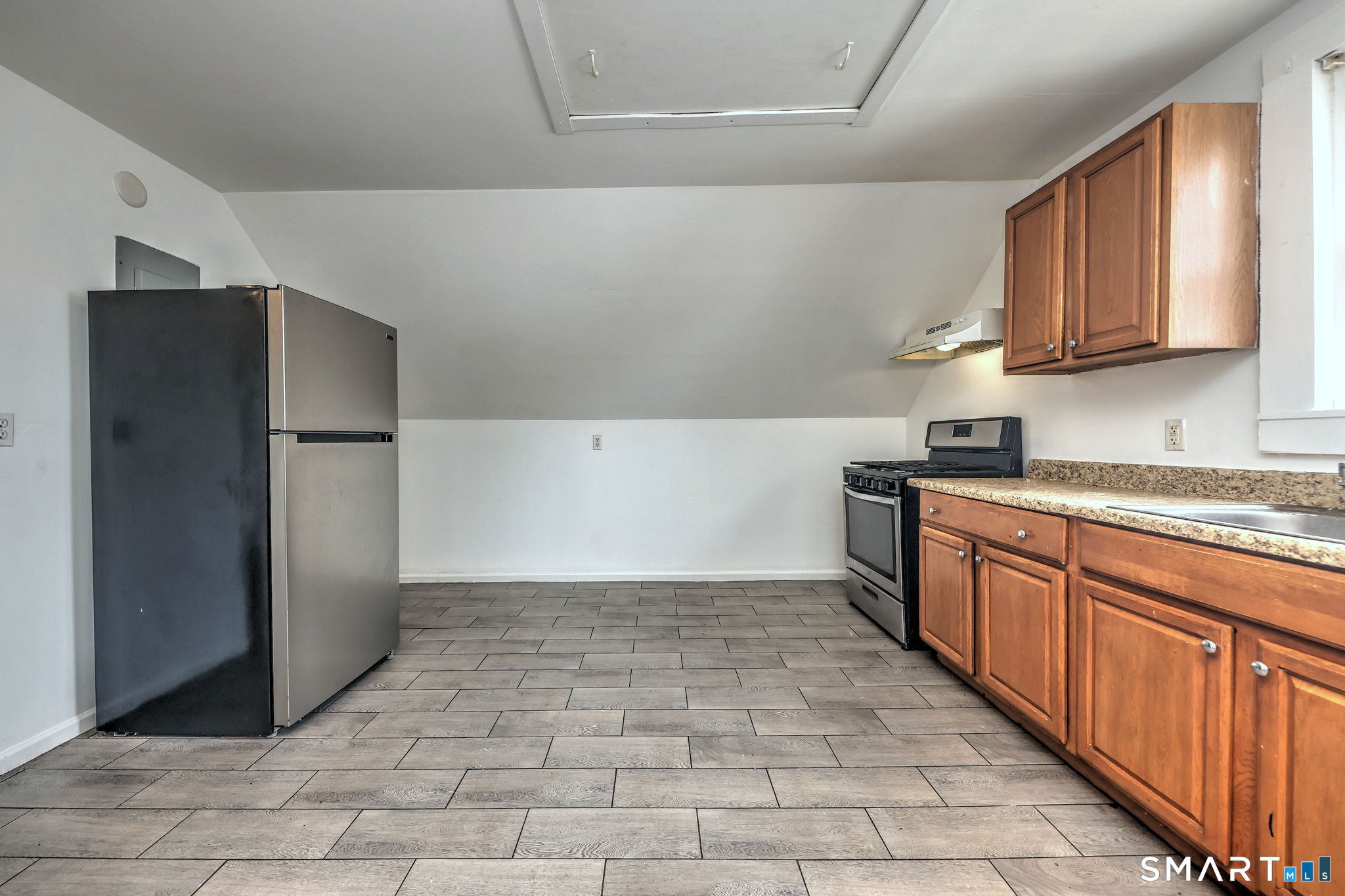 483 Ferry Street, Unit 3 New Haven, CT 06513 - Photo 25 of 28 a kitchen with stainless steel appliances granite countertop a refrigerator and a stove top oven