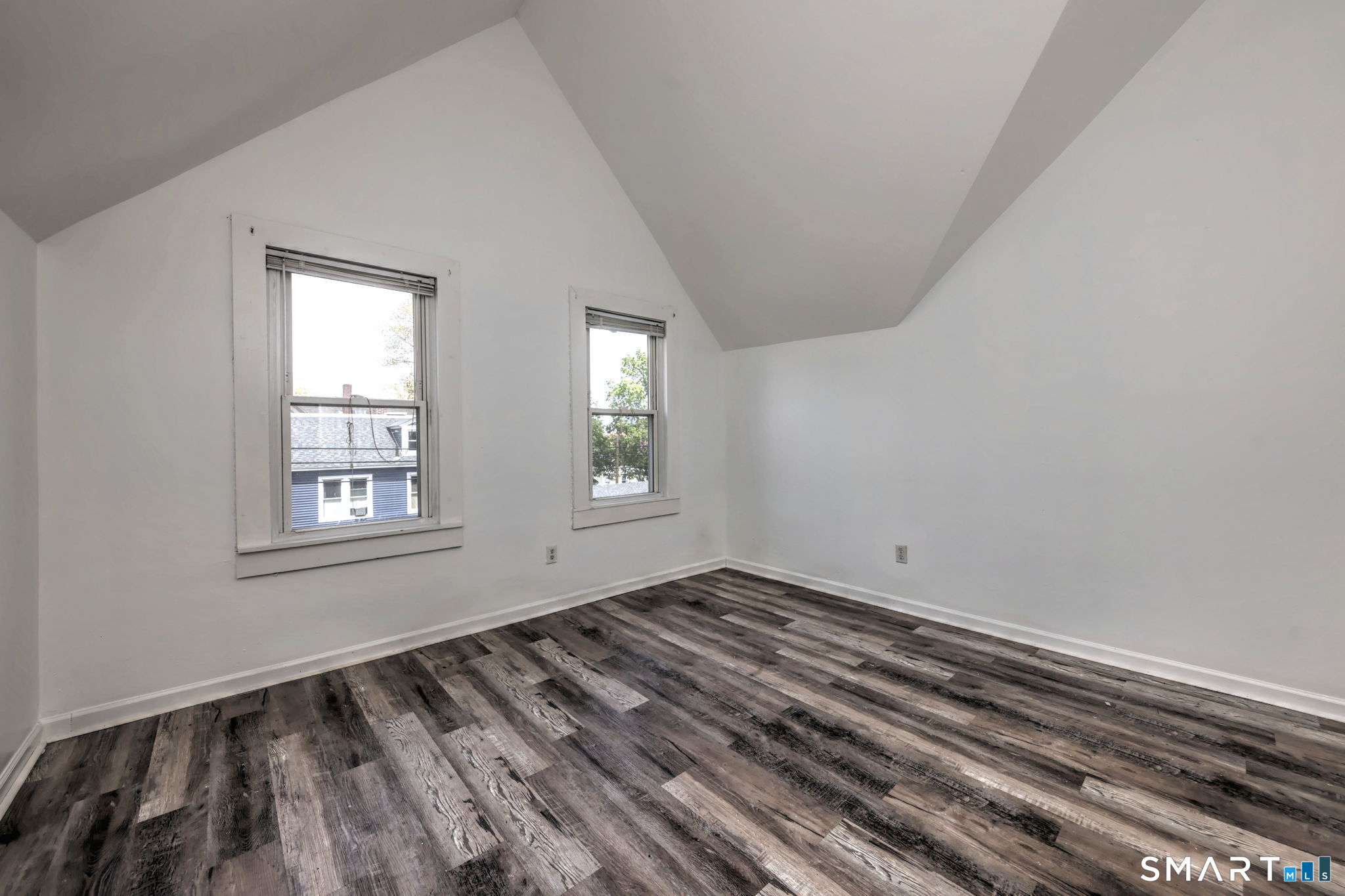483 Ferry Street, Unit 3 New Haven, CT 06513 - Photo 9 of 28 a view of an empty room with wooden floor and a window