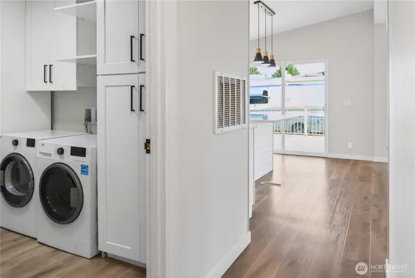 a view of a hallway with washer and dryer