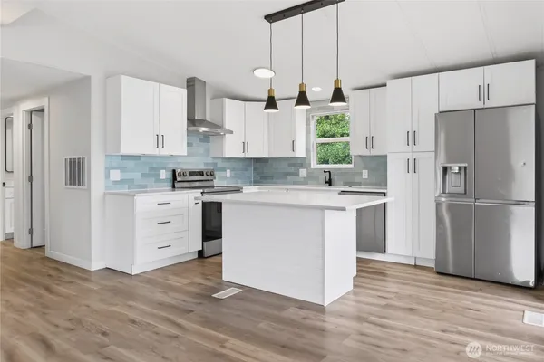 a kitchen with white cabinets stainless steel appliances and sink