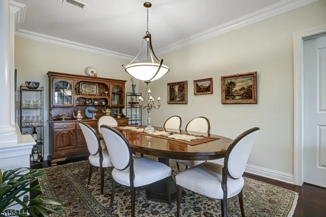a dining room with furniture a rug and wooden floor