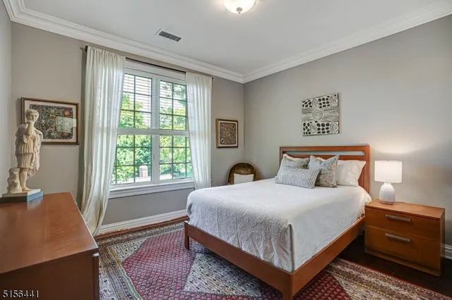 a bedroom with a bed lamp and window