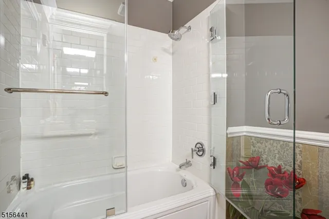 a bathroom with a bathtub and a shower