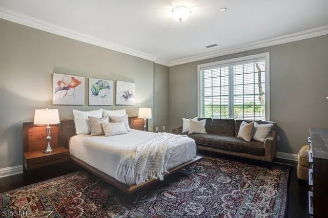 a bedroom with a bed couch and a window