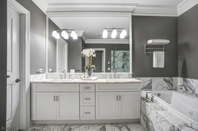 a bathroom with a granite countertop sink mirror and bathtub