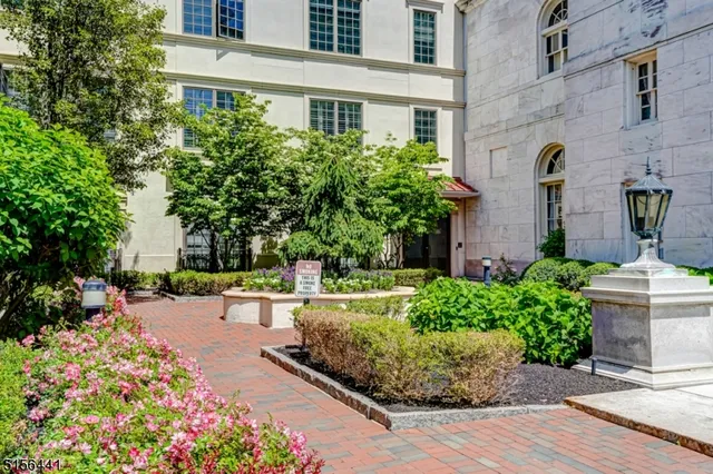 front view of a building with a garden