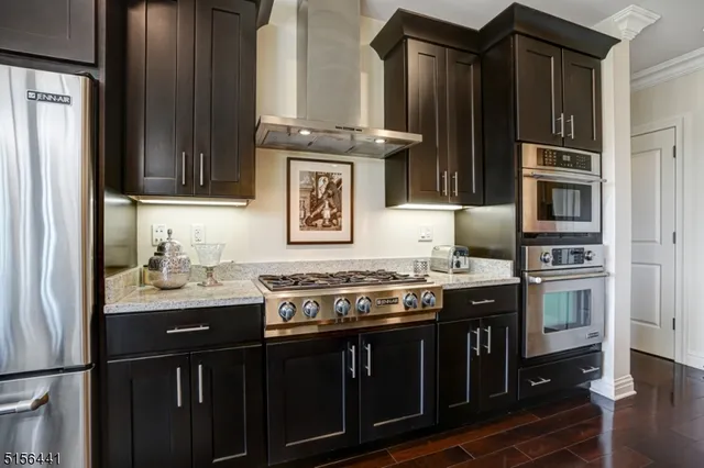 a kitchen with granite countertop a stove and cabinets