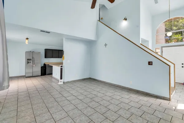 a view of a livingroom with an empty space and a fireplace window