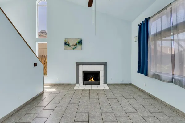 a view of an empty room window and fire place