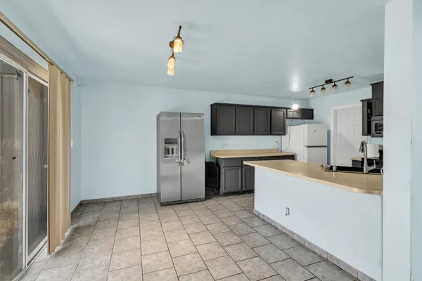a kitchen with stainless steel appliances a refrigerator sink and cabinets