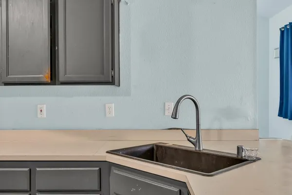 a kitchen with cabinets and stainless steel appliances