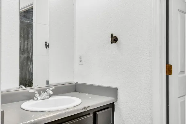 a bathroom with a toilet a sink and mirror