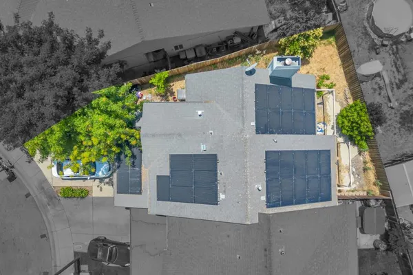 an aerial view of a house with a yard and a garage