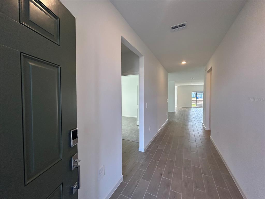 12419 Northwest 139th Court Alachua, FL 32615 - Photo 2 of 38 a view of a hallway with wooden floor