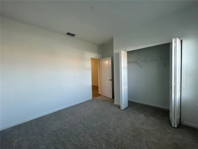 an empty room with closet area
