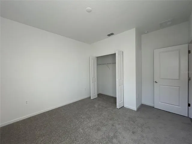 a view of an empty room and closet area