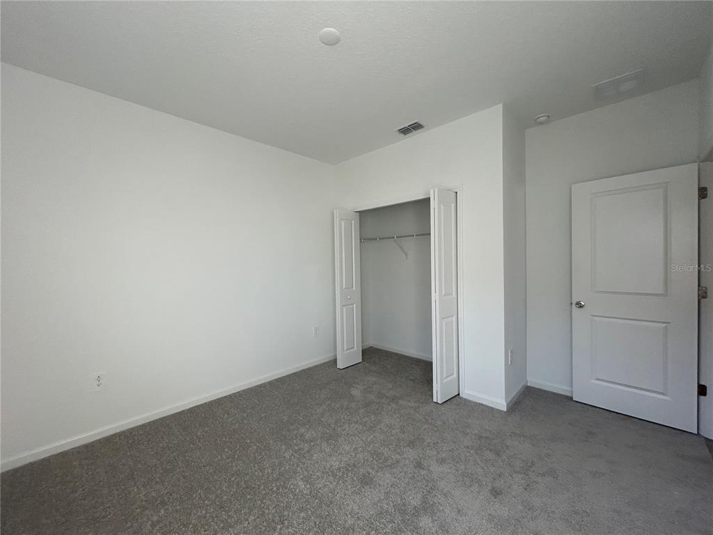 12419 Northwest 139th Court Alachua, FL 32615 - Photo 24 of 38 a view of an empty room and closet area