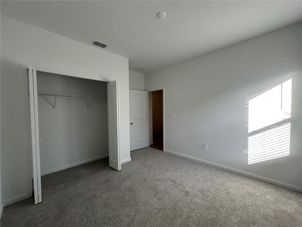 12419 Northwest 139th Court Alachua, FL 32615 - Photo 25 of 38 an empty room with windows and closet