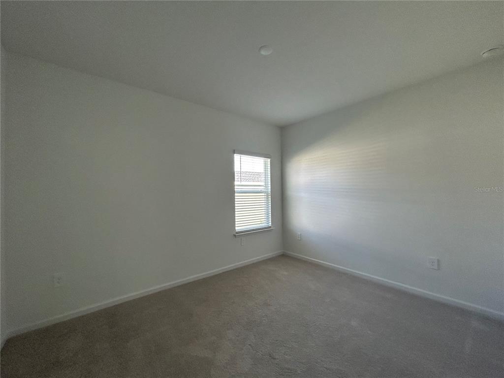 12419 Northwest 139th Court Alachua, FL 32615 - Photo 30 of 38 wooden floor and window in an empty room