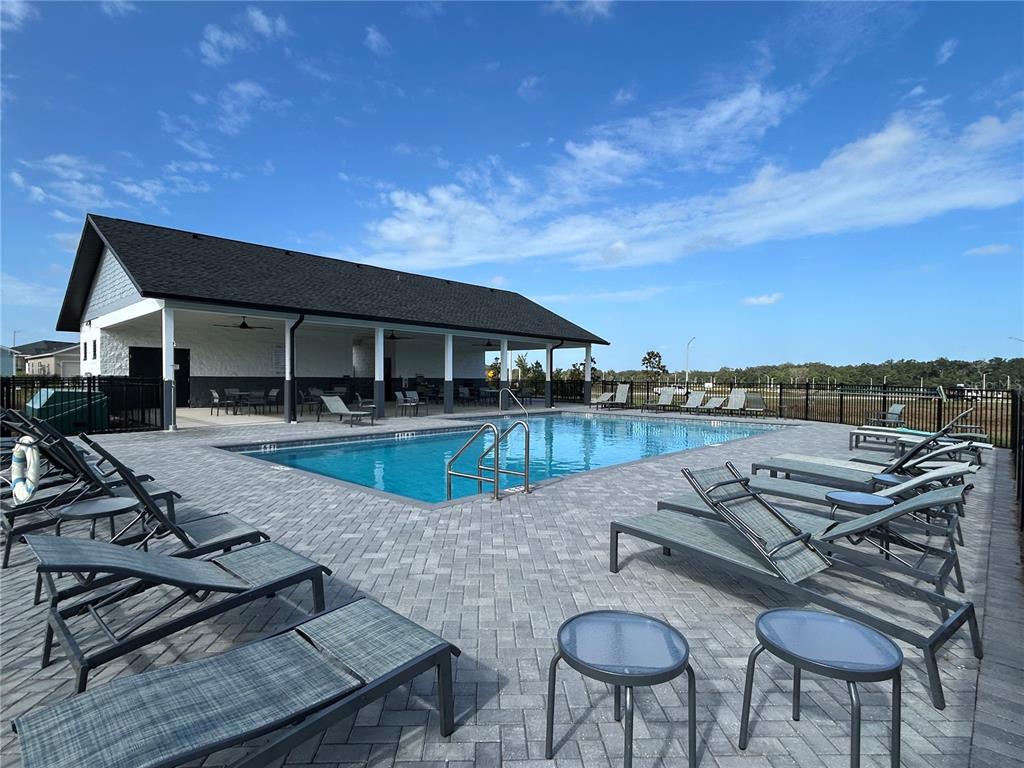 12419 Northwest 139th Court Alachua, FL 32615 - Photo 38 of 38 a view of a swimming pool with lounge chairs