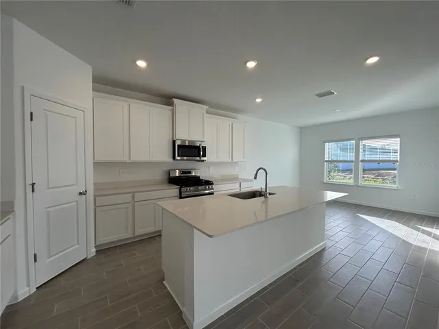 a kitchen with cabinets and white appliances