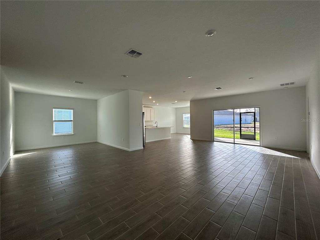 12419 Northwest 139th Court Alachua, FL 32615 - Photo 10 of 38 an empty room with wooden floor and windows