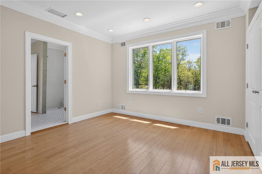 381 Monmouth Road Freehold, NJ 07728 - Photo 51 of 63 a view of an empty room with wooden floor and a window
